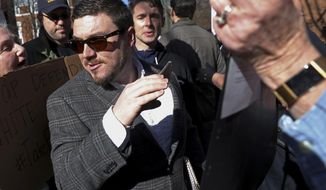 FILE - In this Feb. 27, 2018, file photo, Jason Kessler walks through a crowd of protesters in front of the Charlottesville Circuit Courthouse ahead of a decision regarding the covered Confederate statues, during a rally in Charlottesville, Va. Kessler, a white nationalist, is seeking a court order that would allow him to stage an event marking the anniversary of last year&#39;s rally in Charlottesville. U.S. District Judge Norman Moon scheduled a hearing Tuesday, July 24, on Kessler&#39;s request for a preliminary injunction that would compel the city of Charlottesville to issue him a rally permit for August. (Zack Wajsgras/The Daily Progress via AP, File)