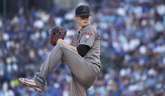 Arizona Diamondbacks starting pitcher Clay Buchholz winds up during the first inning of the team&#x27;s baseball game against the Chicago Cubs on Tuesday, July 24, 2018, in Chicago. (AP Photo/Charles Rex Arbogast)