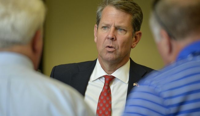 Georgia Secretary of State Brian Kemp talks to voters during a rally in Augusta, Ga., Monday, July 23, 2018, as he continues his campaign for Georgia governor, a day before the Republican runoff election against his opponent, Georgia&#x27;s Lt. Governor, Casey Cagle. (Michael Holahan/The Augusta Chronicle via AP)