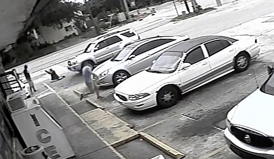 In this Thursday, July 19, 2018 image taken from surveillance video released by the Pinellas County Sheriff&#39;s Office, Markeis McGlockton, far left, is shot by Michael Drejka during an altercation in the parking lot of a convenience store in Clearwater, Fla. The family of McGlockton issued an appeal Tuesday, July 24, 2018, through an attorney for the public to put pressure on State Attorney Bernie McCabe to file charges against Drejka, a white man who fatally shot the black father of three last Thursday upon being pushed to the ground outside a convenience store. (Pinellas County Sheriff&#39;s Office via AP)