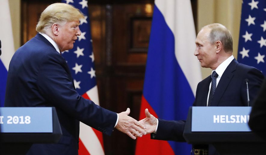 In this file photo taken on Monday, July 16, 2018, U.S. President Donald Trump shakes hand with Russian President Vladimir Putin at the end of the press conference after their meeting at the Presidential Palace in Helsinki, Finland. (AP Photo/Alexander Zemlianichenko, File)