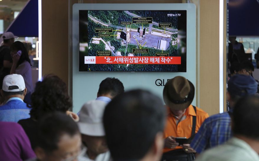 A TV screen shows a satellite image of North Korea's Sohae launch site, during a news program at the Seoul Railway Station in Seoul, South Kore, Tuesday, July 24, 2018. A U.S. research group says North Korea has started dismantling key facilities at its main satellite launch site in what appears to be a step toward fulfilling a commitment made by leader Kim Jong-un at his summit with President Donald Trump in June. The signs read: "North Korea begins dismantling satellite launch site." (AP Photo/Ahn Young-joon)