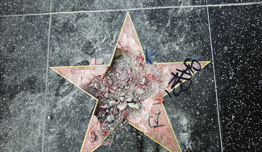 This photo shows Donald Trump's star on the Hollywood Walk of Fame that was vandalized Wednesday, July 25, 2018, in Los Angeles. Los Angeles police Officer Ray Brown said the vandalism was reported early Wednesday and someone was subsequently taken into custody. Authorities said a pickax was used in the vandalism. (AP Photo/Reed Saxon)