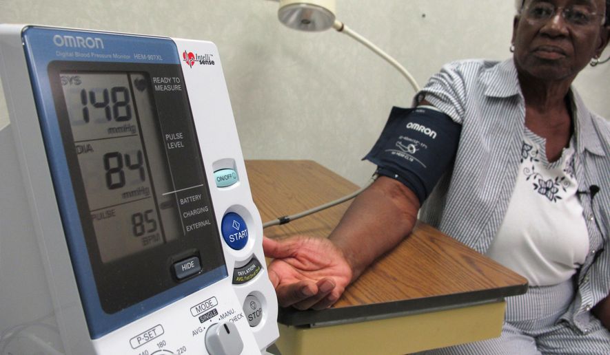 Margaret Graham, 74, has her blood pressure checked while visiting the Wake Forest Baptist Medical Center in Winston-Salem, N.C., on Friday, July 13, 2018. She had participated in a multi-year study, published on Wednesday, July 25, 2018, investigating a connection between high blood pressure and the risk of mental decline. "I feel like maybe with this study, some findings may come that will develop new drugs and also new activities, exercise, theories that will help people to maintain an acceptable blood pressure level," Graham says. (AP Photo/Allen G. Breed)