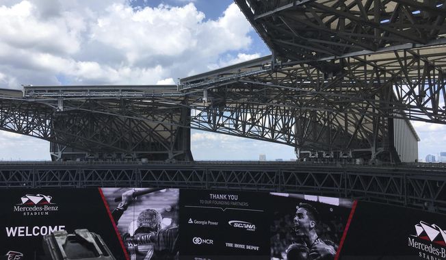Blue sky and sunshine are seen through the roof of the Mercedes-Benz Stadium after the roof was opened during a demonstration for the media Wednesday, July 25, 2018, in Atlanta. The roof was closed for most of the 2017 NFL season due to design problems and now can be opened and closed in minutes. (AP Photo/Paul Newberry)