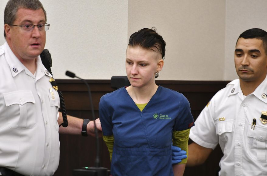 Julia Enright is brought into Gardner District Court for arraignment, Tuesday, July 24, 2018 in Worcester, Mass. She has been charged with the slaying of 20-year-old Brandon Chicklis, whose body was found near a New Hampshire road earlier this month. (Christine Peterson/Worcester Telegram & Gazette via AP)