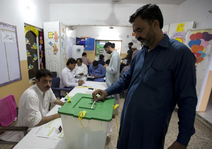 A Pakistani casts his vote at a polling station for the parliamentary elections in Islamabad, Pakistan, Wednesday, July 25, 2018. After an acrimonious campaign, polls opened in Pakistan on Wednesday to elect the country's third straight civilian election, a first for this majority Muslim nation that has been directly or indirectly ruled by its military for most of its 71-year history. (AP Photo/B.K. Bangash)