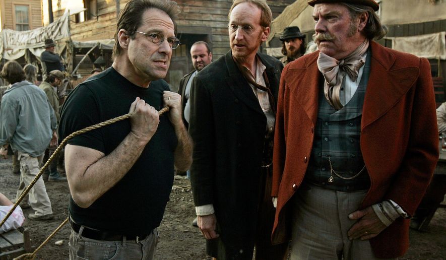 FILE - In this Feb. 9, 2005 file photo, David Milch, left, creator of the HBO series "Deadwood," appears on the set with Larry Cedar, center, and Peter Jason in Santa Clarita, Calif. HBO says it's greenlighted a long-discussed movie based on the Western drama that ended a dozen years ago. The critically acclaimed, award-winning series was set in the rough-and-tumble South Dakota mining town of the title. (AP Photo/Kevork Djansezian, File)