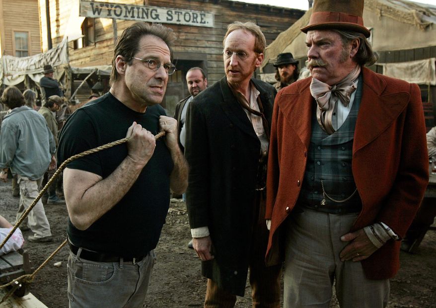 FILE - In this Feb. 9, 2005 file photo, David Milch, left, creator of the HBO series "Deadwood," appears on the set with Larry Cedar, center, and Peter Jason in Santa Clarita, Calif. HBO says it's greenlighted a long-discussed movie based on the Western drama that ended a dozen years ago. The critically acclaimed, award-winning series was set in the rough-and-tumble South Dakota mining town of the title. (AP Photo/Kevork Djansezian, File)