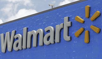 FILE - This June 1, 2017, file photo, shows a Walmart sign at a store in Hialeah Gardens, Fla. Google spinoff Waymo says it&#39;s launching a pilot program with Walmart that will allow customers to use its self-driving car service to pick up groceries at Walmart stores. Waymo said in a blog post on Wednesday, July 25, 2018 that the program, which will be tested in Phoenix, will help make shopping more convenient. (AP Photo/Alan Diaz, File)