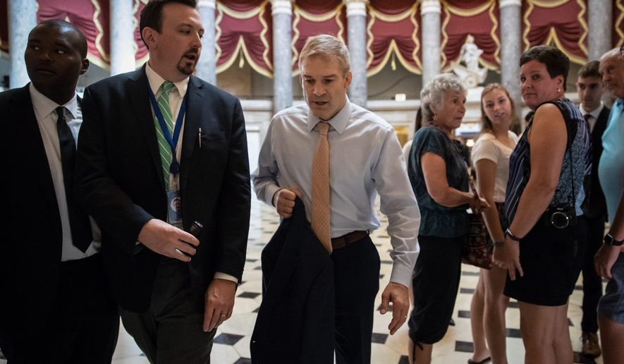 Rep. Jim Jordan, Ohio Republican, (center) has built a reputation as a right-wing brawler, willing to battle Democrats and Republican leaders alike. He is challenging Rep. Kevin McCarthy, of California, to succeed outgoing House Speaker Paul D. Ryan.
walks to the House chamber as he prepares to file articles of impeachment against Deputy Attorney General Rod J. Rosenstein, on Capitol Hill in Washington, Thursday, July 26, 2018. (AP Photo/J. Scott Applewhite) (Associated Press photographs)