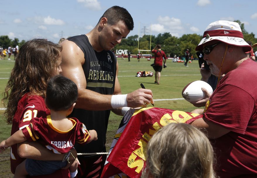 Washington Redskins line backer Ryan Kerrigan signs autographs after the morning session of the Redskins NFL football training camp in Richmond, Va., Thursday, July 26, 2018. (AP Photo/Steve Helber)