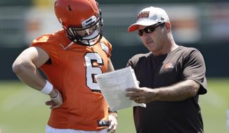 Cleveland Browns quarterbacks coach Ken Zampese, right, talks with quarterback Baker Mayfield at the NFL football team&#39;s training camp facility, Thursday, July 26, 2018, in Berea, Ohio. (AP Photo/Tony Dejak)