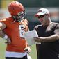 Cleveland Browns quarterbacks coach Ken Zampese, right, talks with quarterback Baker Mayfield at the NFL football team&#x27;s training camp facility, Thursday, July 26, 2018, in Berea, Ohio. (AP Photo/Tony Dejak)