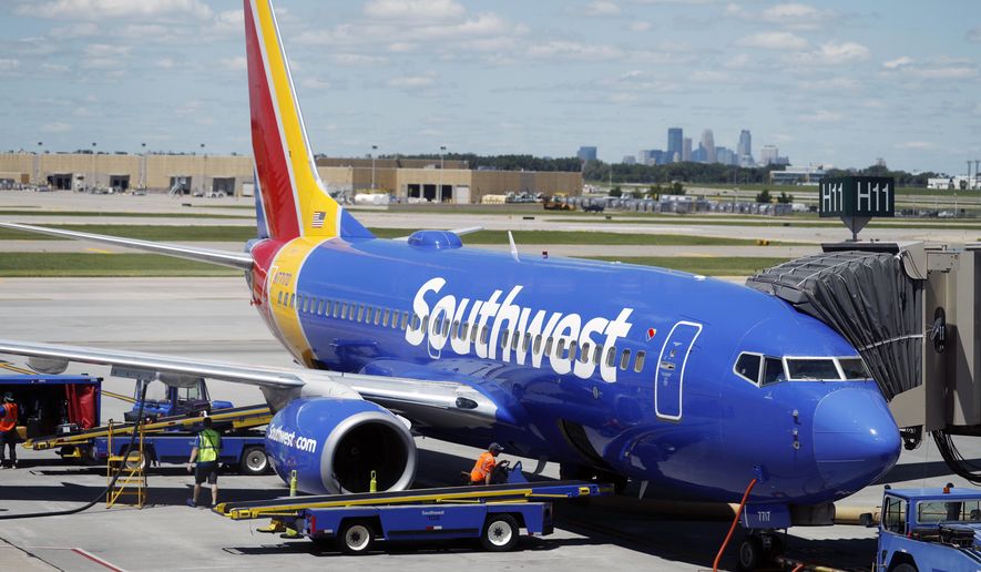 In this July 17, 2018, file photograph, ramp workers prepare a Southwest Airlines Boeing 737 for departure to Denver from Minneapolis International Airport in Minneapolis. (AP Photo/David Zalubowski) ** FILE **