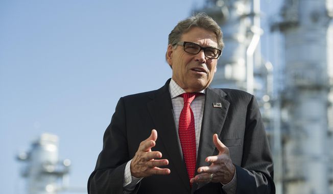 Secretary of Energy Rick Perry stands with the main cyrogenic heat exchange as he speaks with reporters at Dominion Energy&#x27;s Cove Point LNG liquefaction Project facility in Lusby, Md., Thursday, July 26, 2018. The completion of the facilities export expansion project makes it just the second LNG export facility in the U.S. (AP Photo/Cliff Owen)