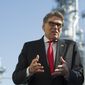 Secretary of Energy Rick Perry stands with the main cyrogenic heat exchange as he speaks with reporters at Dominion Energy&#39;s Cove Point LNG liquefaction Project facility in Lusby, Md., Thursday, July 26, 2018. The completion of the facilities export expansion project makes it just the second LNG export facility in the U.S. (AP Photo/Cliff Owen)