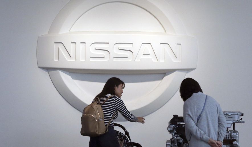 In this Nov. 10, 2017, file photo, visitors walk around a gallery of the Nissan Motor Co. at its global headquarters in Yokohama, near Tokyo. Nissan Motor Co. says its profits plunged 14 percent in the latest quarter as U.S. and European sales fell sharply and raw material costs rose. (AP Photo/Koji Sasahara, file)