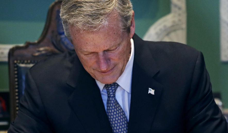 In this file photo, Gov. Charlie Baker signs the 2019 budget at the Statehouse in Boston, Thursday, July 26, 2018. (AP Photo/Charles Krupa) **FILE**