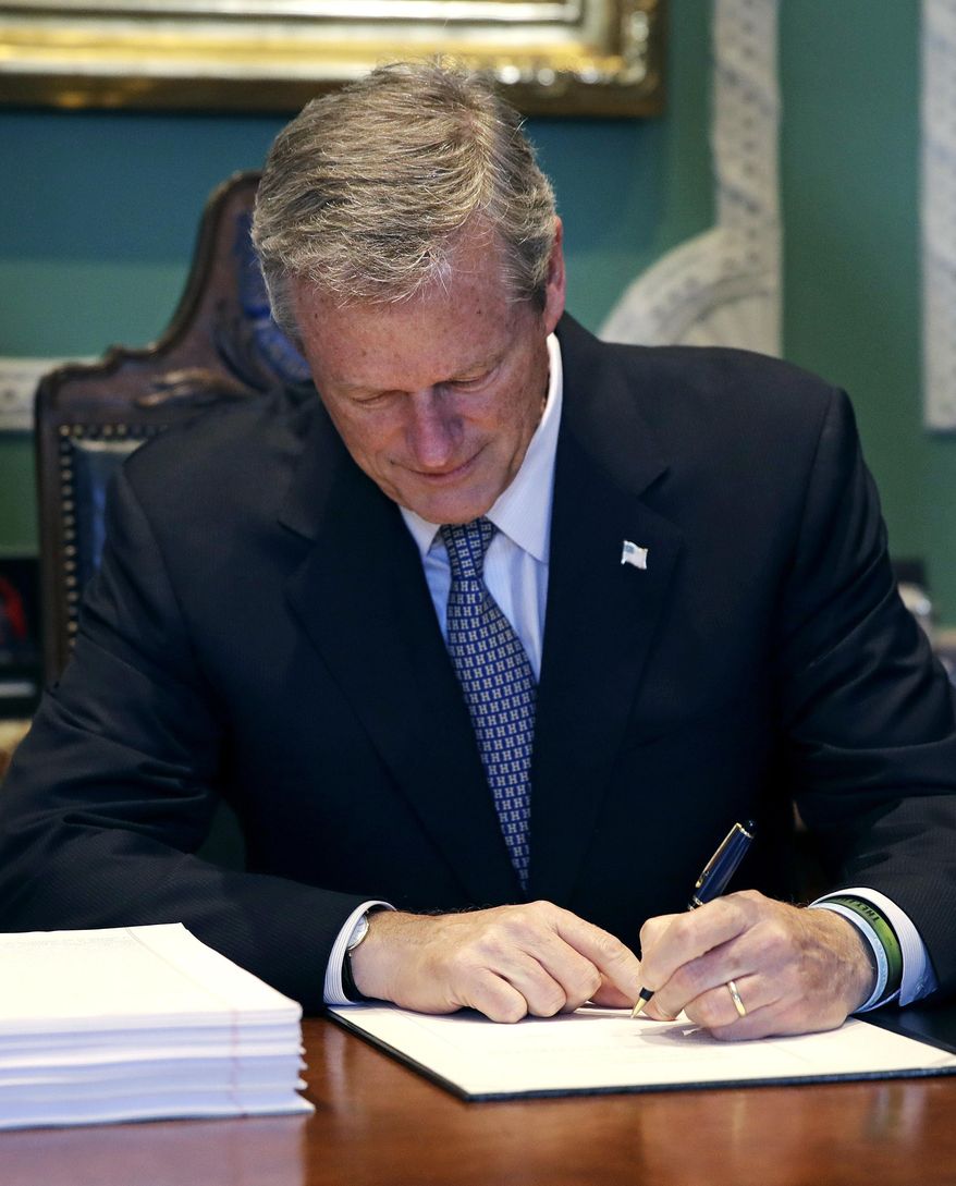 In this file photo, Gov. Charlie Baker signs the 2019 budget at the Statehouse in Boston, Thursday, July 26, 2018. (AP Photo/Charles Krupa) **FILE**