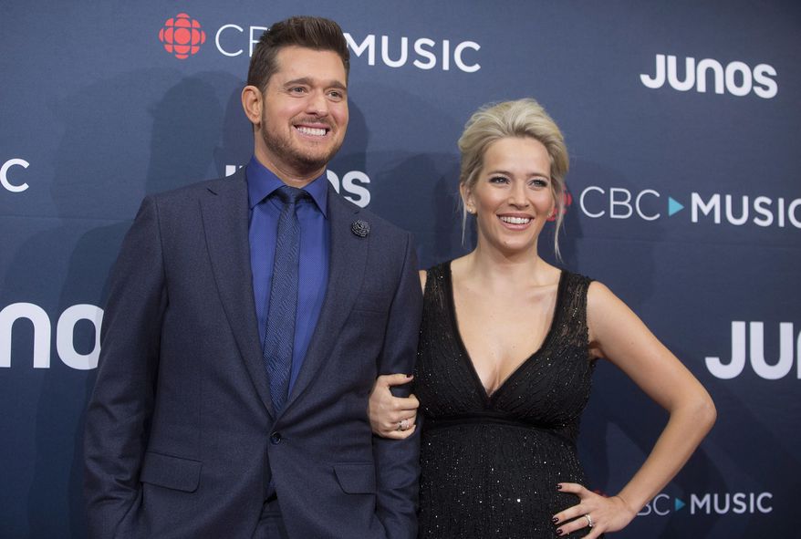 FILE - In this March 25, 2018 file photo, Michael Buble and his wife Luisana Lopilato at the Juno Awards in Vancouver, British Columbia. Buble and Lopilato are the proud parents of a baby girl. Buble’s representative says that Vida Amber Betty was born Wednesday in Vancouver. She is 6 pounds, 1 ounce. Buble and Lopilato also have two sons, Elias and Noah. Lopilato, an Argentine TV actress, posted a photo of her baby girl’s hand Thursday on Instagram. (Darryl Dyck/The Canadian Press via AP, File)