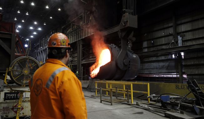 In this June 28, 2018 photo, senior melt operator Randy Feltmeyer watches a giant ladle as it backs away after pouring its contents of red-hot iron into a vessel in the basic oxygen furnace as part of the process of producing steel at the U.S. Steel Granite City Works facility in Granite City, Ill. President Donald Trump will visit the facility on Thursday, July 26, 2018. U.S. Steel credited Trump&#x27;s plan to impose tariffs on imported steel and aluminum when the company announced in March it was firing up a furnace at Granite City Works that had been idled for more than two years. (AP Photo/Jeff Roberson)