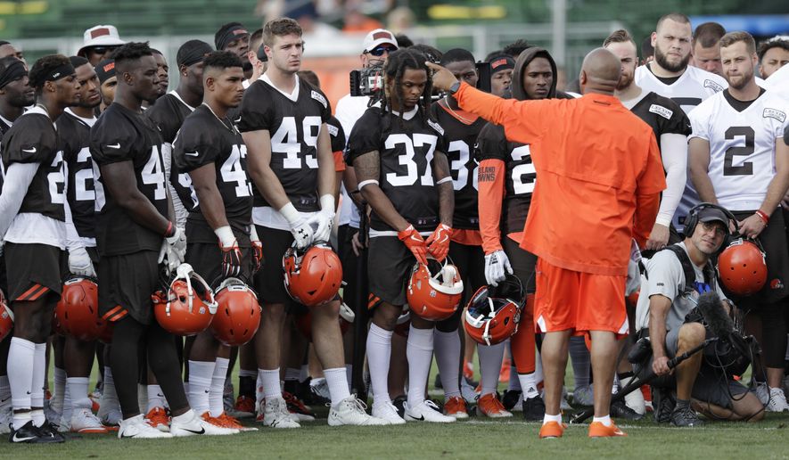 Cleveland Browns head coach Hue Jackson, front right, talks with the team during NFL football training camp, Friday, July 27, 2018, in Berea, Ohio. (AP Photo/Tony Dejak)