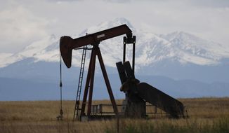 In this Friday, May 27, 2016, photo, a pump jack works off state highway 119 near Firestone, Colo.  (AP Photo/David Zalubowski, File)  **FILE**