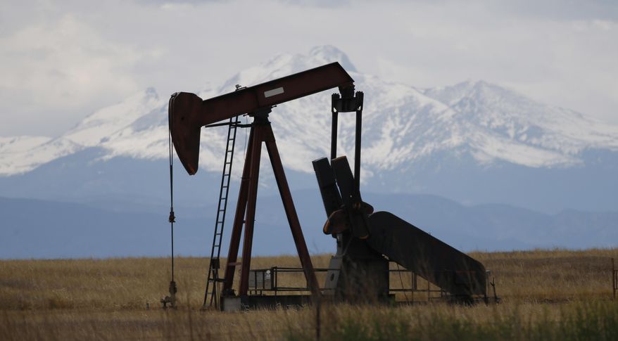 In this Friday, May 27, 2016, photo, a pump jack works off state highway 119 near Firestone, Colo. (AP Photo/David Zalubowski, File) **FILE**
