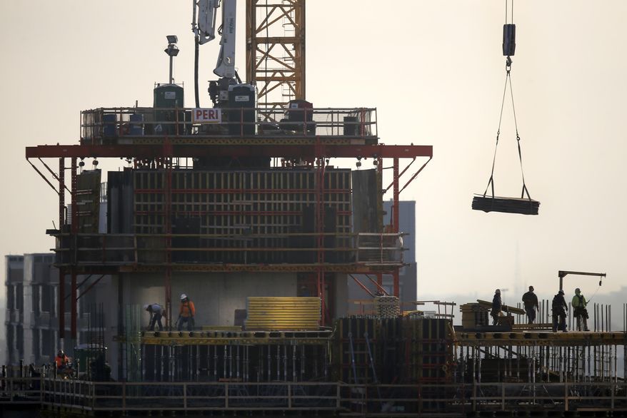 FILE - In this Jan. 18, 2017 file photo, construction personnel work on a building project just south of Chicago's Loop. The U.S. economy surged in the April-June quarter, growing at an annual rate of 4.1 percent. That's the fastest pace since 2014, driven by consumers who began spending their tax cuts and exporters who sought to get their products delivered ahead of retaliatory tariffs. (AP Photo/Charles Rex Arbogast)