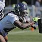 Seattle Seahawks linebacker Shaquem Griffin hits a blocking sled during NFL football training camp, Thursday, July 26, 2018, in Renton, Wash. (AP Photo/Ted S. Warren)