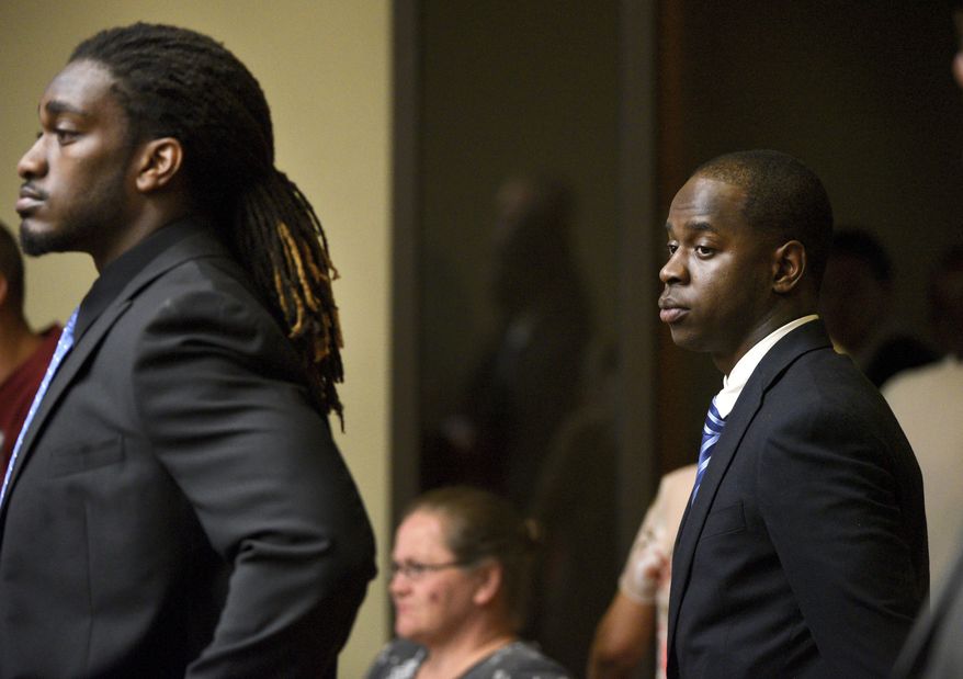 FILE - In this Aug. 24, 2015, file photo, former University of Tennessee football players Michael Williams, right, and A.J. Johnson stand in court before the start of Williams's rape trial in Knoxville, Tenn. Jurors acquitted Friday, July 27, 2018, the two former University of Tennessee football players who were indicted on aggravated rape charges nearly 3 1/2 years ago. (Michael Patrick/Knoxville News Sentinel via AP, File)