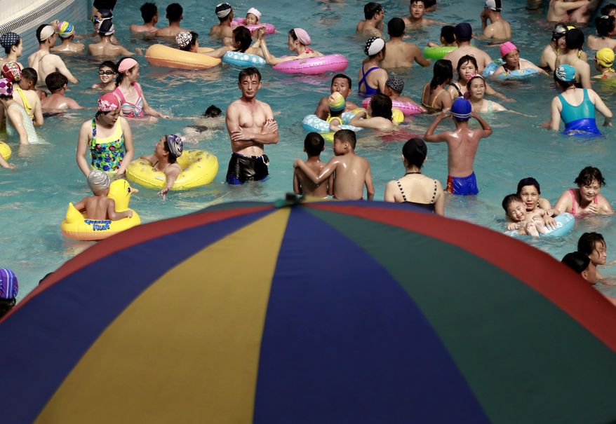 In this Tuesday, July 24, 2018, photo, North Koreans spend their afternoon in an indoor swimming pool at Munsu Water Park during a hot day in Pyongyang, North Korea. (AP Photo/Dita Alangkara, File)