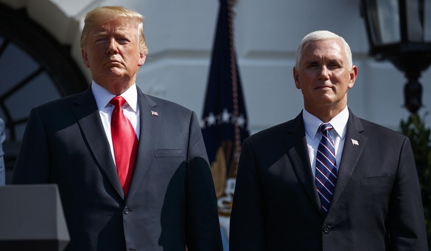President Donald Trump stands with Vice President Mike Pence after delivering remarks about the economy on the South Lawn of the White House, Friday, July 27, 2018, in Washington. (AP Photo/Evan Vucci)