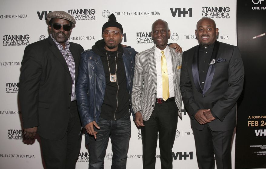 FILE - In this Feb. 20, 2014 file photo, from left, recording artists Fab Five Freddy and Nas, fashion designer Dapper Dan and author Steve Stoute attend a screening of "The Tanning of America: One Nation Under Hip Hop" in New York. Harlem designer Dapper Dan spent years in the 1980s with a client list that included the who's who of hip-hop before legal issues over the clothes he was making got in the way. Now the fashion groundbreaker is back after more than two decades out of the public eye. He's got a partnership with Gucci and the likes of superstar entertainer Beyonce among those wearing his designs. (Photo by Andy Kropa/Invision/AP)
