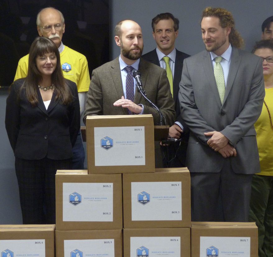 Josh Hovey, spokesman for the Coalition to Regulate Marijuana Like Alcohol, speaks at a news conference in Lansing, Mich., where group submitted more than 360,000 signatures for a 2018 ballot drive to legalize the use of marijuana for recreational purposes. A proposal to legalize marijuana has sprouted on Michigan's November ballot, putting the state on the cusp of allowing recreational use of the drug for those 21 and older. It could also entice younger voters to show up to the polls, which could help the Democrats. (AP Photo/David Eggert, File)
