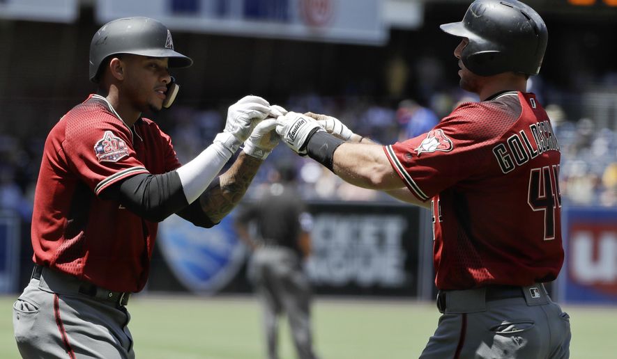 Arizona Diamondbacks&#39; Paul Goldschmidt, right, is greeted by teammate Ketel Marte, left, after hitting a two-run home run during the first inning of a baseball game Sunday, July 29, 2018, in San Diego. (AP Photo/Gregory Bull)