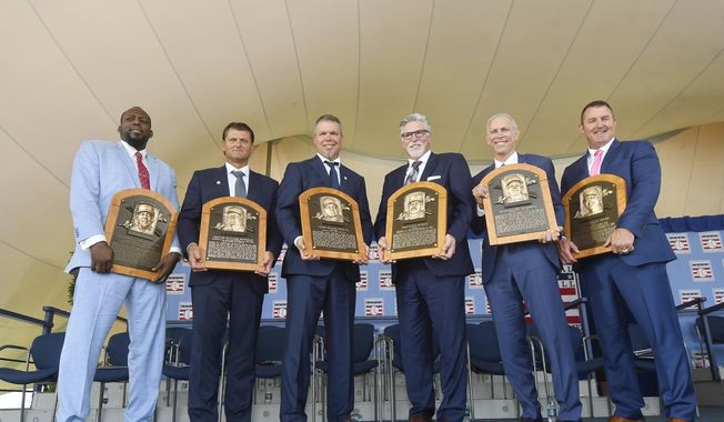 Baseball Hall of Famers from left, Vladimir Guerrero, Trevor Hoffman, Chipper Jones, Jack Morris, Alan Trammell, and Jim Thome, hold their plaques after an induction ceremony at the Clark Sports Center on Sunday, July 29, 2018, in Cooperstown, N.Y. (AP Photo/Hans Pennink)