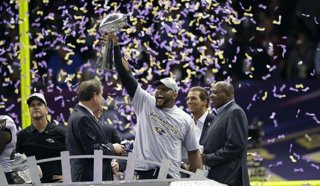 FILE - In this Feb. 3, 2013, file photo, Baltimore Ravens linebacker Ray Lewis, center, celebrates with the Vince Lombardi Trophy after defeating the San Francisco 49ers 34-31 in the NFL Super Bowl XLVII football game in New Orleans. Ray Lewis will be enshrined Saturday at the Football Hall of Fame in Canton, Ohio. (AP Photo/Marcio Sanchez, File)