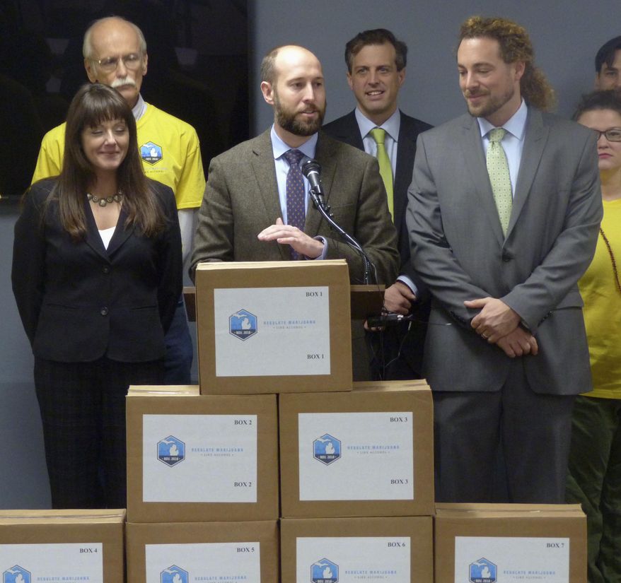 FILE - In this Nov. 20, 2017, file photo, Josh Hovey, spokesman for the Coalition to Regulate Marijuana Like Alcohol, speaks at a news conference in Lansing, Mich., where group submitted more than 360,000 signatures for a 2018 ballot drive to legalize the use of marijuana for recreational purposes. A proposal to legalize marijuana has sprouted on Michigan's November ballot, putting the state on the cusp of allowing recreational use of the drug for those 21 and older. It could also entice younger voters to show up to the polls, which could help the Democrats. (AP Photo/David Eggert, File)