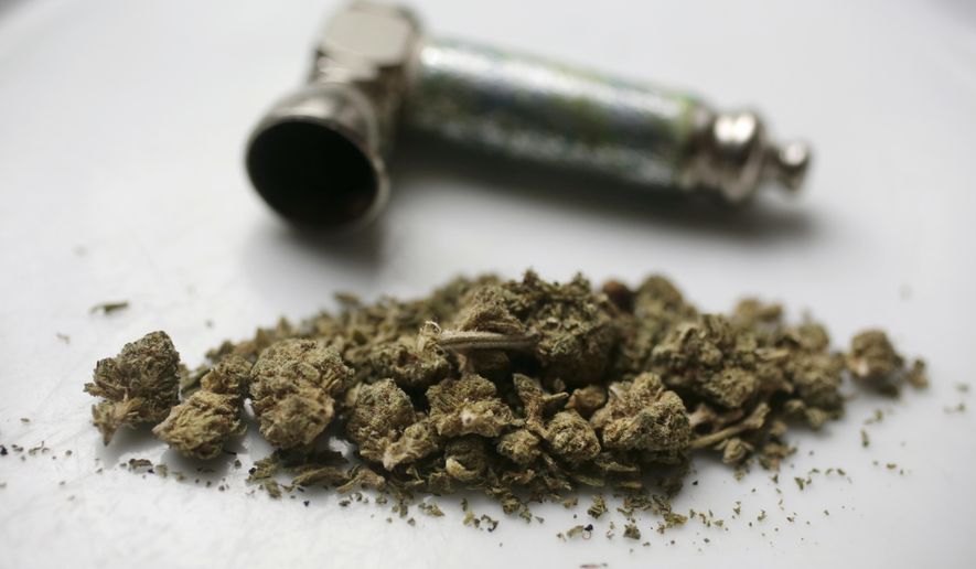 In this June 20, 2018, file photo, marijuana and a pipe used to smoke it are displayed in New York. (AP Photo/Peter Morgan, File)