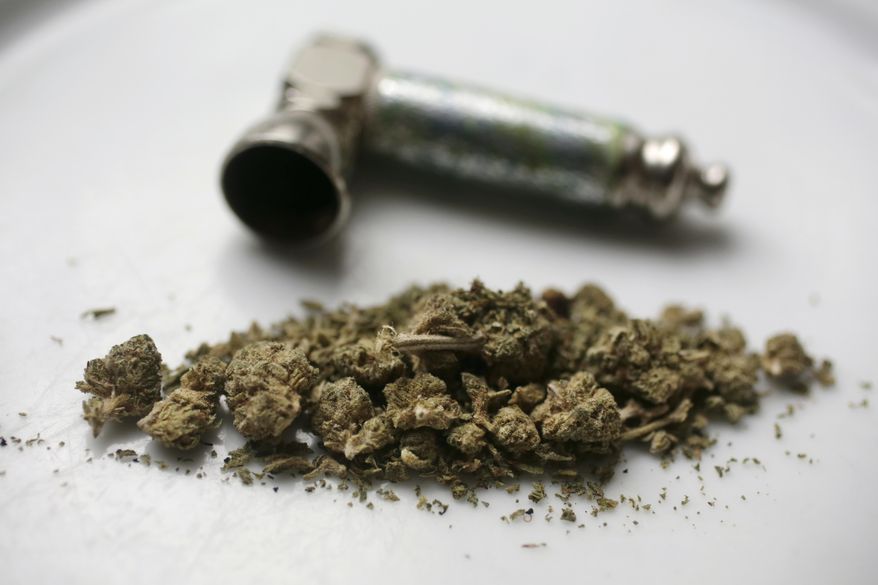 In this June 20, 2018, file photo, marijuana and a pipe used to smoke it are displayed in New York. (AP Photo/Peter Morgan, File)