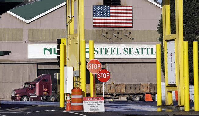 FILE - In this Feb. 25, 2016 file photo, a truck carries a load at the Nucor Steel plant in Seattle. U.S. companies pursuing exemptions from President Donald Trump’s tariff on imported steel are accusing American steel manufacturers of spreading inaccurate and misleading information, and they fear it may torpedo their requests. The president of one company calls objections raised by U.S. Steel and Nucor to his waiver request “literal untruths.”(AP Photo/Elaine Thompson, File)