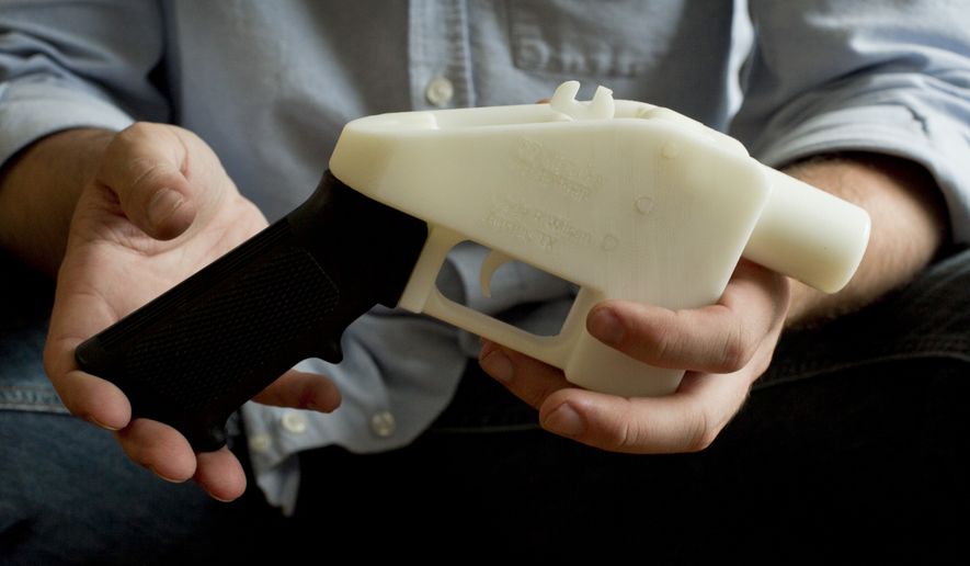 In this May 10, 2013, file photo, Cody Wilson holds what he calls a Liberator pistol that was completely made on a 3D-printer at his home in Austin, Texas. Eight states filed suit Monday, July 30, 2018, against the Trump administration over its decision to allow a Texas company to publish downloadable blueprints for a 3D-printed gun, contending the hard-to-trace plastic weapons are a boon to terrorists and criminals and threaten public safety. (Jay Janner/Austin American-Statesman via AP, File)