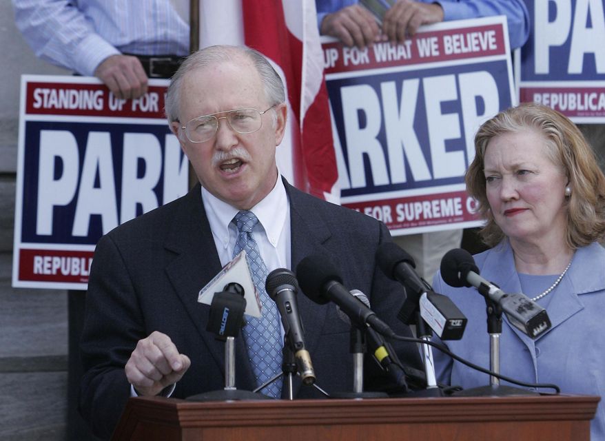 FILE - In this April 5, 2006, file photo, Alabama Supreme Court Justice Tom Parker announces plans to run for chief justice on the steps of the state judicial building in Montgomery, Ala. Parker&#39;s wife, Dottie, is by his side. Alabama firebrand Roy Moore fell short in his quest to become a U.S. senator, but one of his longtime allies could soon take over as the state’s chief justice. And like Moore, Justice Parker sees the state courts as a battleground for reversing U.S. Supreme Court decisions legalizing same-sex marriage and abortion. His Republican primary win sets up a November contest against county circuit judge Bob Vance, who if elected would become the only Democrat on Alabama’s top court. (AP Photo/Jamie Martin, File)