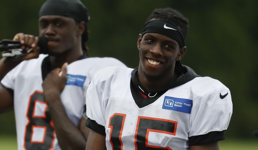 Cincinnati Bengals wide receiver John Ross smiles on the field during NFL football practice, Monday, July 30, 2018, in Cincinnati. (AP Photo/John Minchillo)