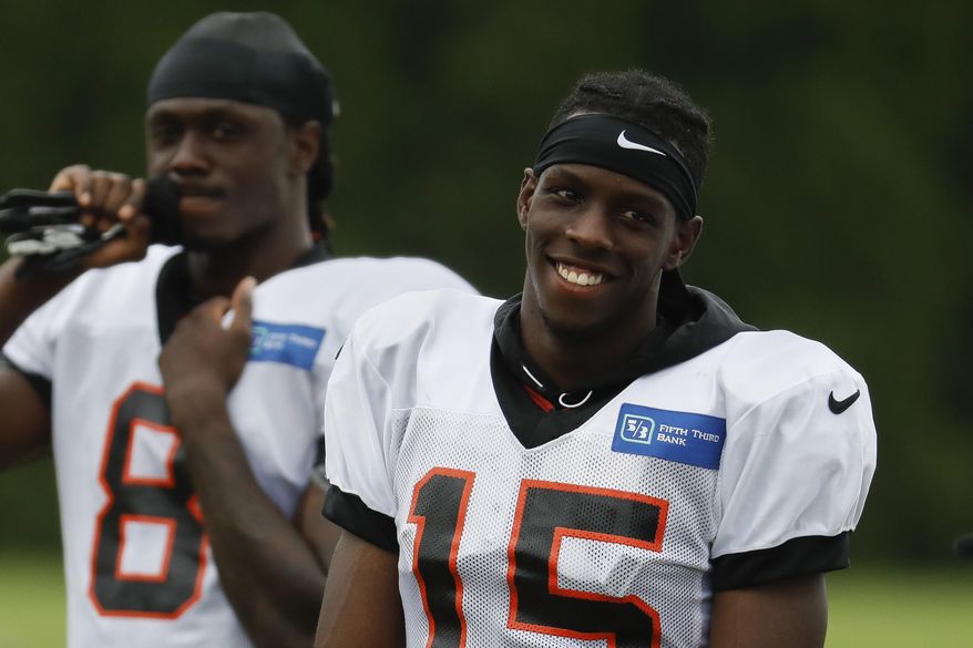 Cincinnati Bengals wide receiver John Ross smiles on the field during NFL football practice, Monday, July 30, 2018, in Cincinnati. (AP Photo/John Minchillo)