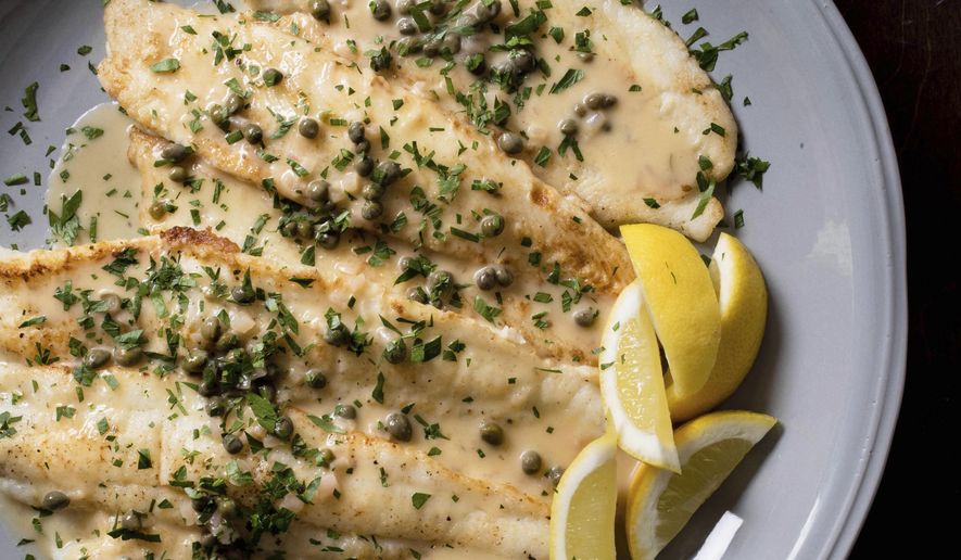 This undated photo provided by America's Test Kitchen in July 2018 shows pan-fried sole with lemon-caper pan sauce in Brookline, Mass. This recipe appears in the cookbook “Just Add Sauce.” (Carl Tremblay/America's Test Kitchen via AP)