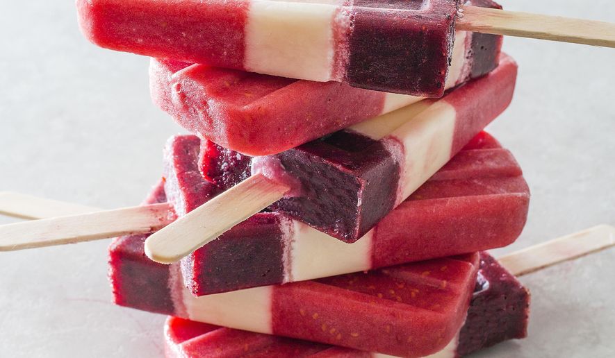 This undated photo provided by America's Test Kitchen in July 2018 shows striped fruit popsicles in Brookline, Mass. This recipe appears in the cookbook “Naturally Sweet.” (Carl Tremblay/America's Test Kitchen via AP)