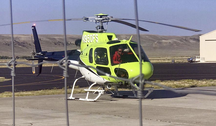 A helicopter brings Garrett Hunter, of Draper, Utah, to the Pinedale, Wyo., Airport after he was rescued from the Bridger Wilderness the previous night. Hunter became lost on Saturday morning and spent nearly 37 hours alone, surviving in part on bugs and tree bark. (Sgt. Travis Bingham/Sublette County Sheriff's Office via AP)